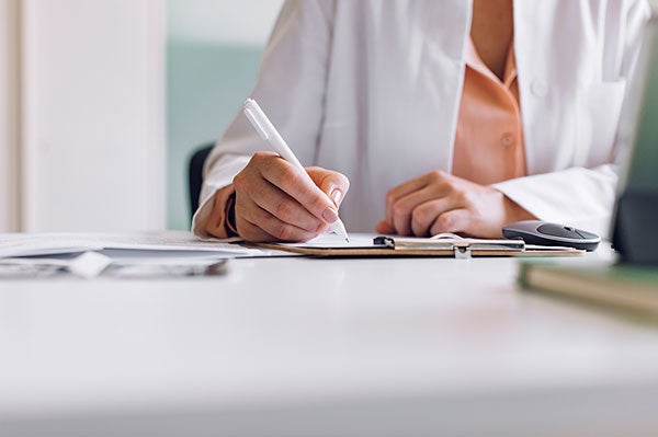 Physician writing a referral
