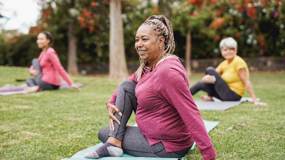A group of woman exercising in a park
