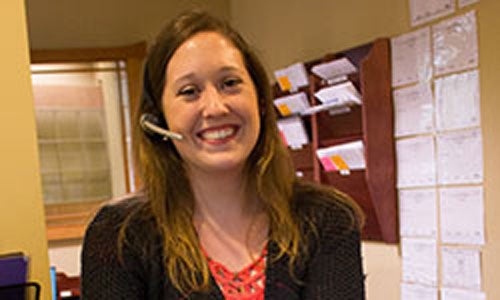 Medical receptionist smiling at the camera