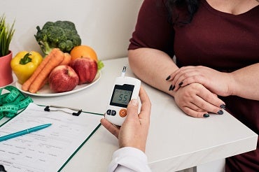 Patient having blood sugar level checked at the doctor's office.