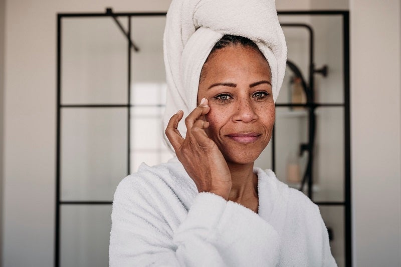 Woman doing her skin routine in her bathroom.