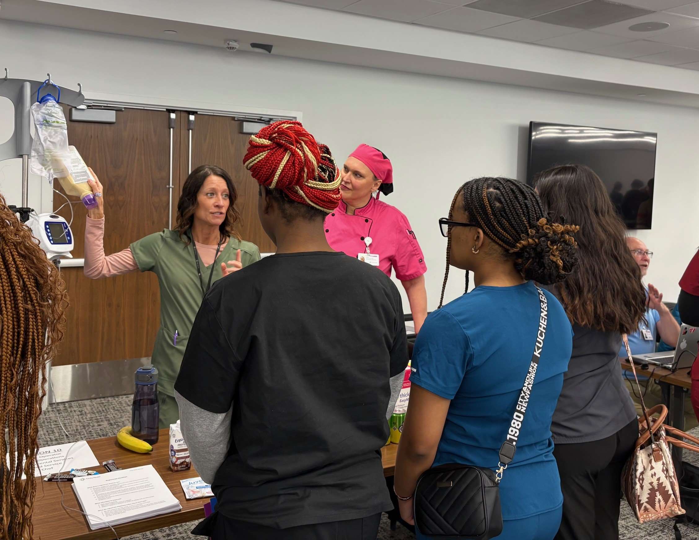 students with a clinical staff person showing them an IV