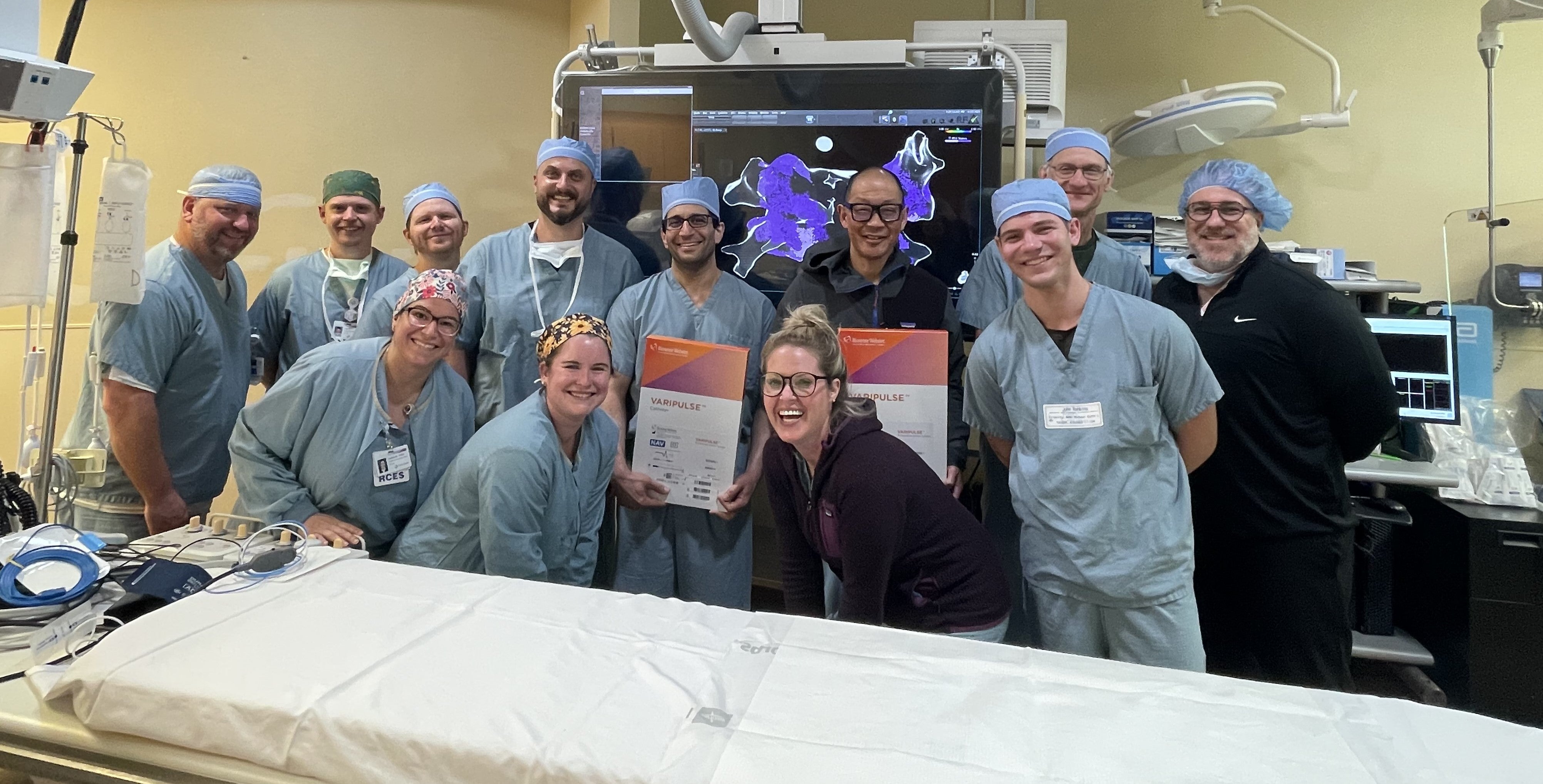 health care group holds certificate in front of VARIPULSE