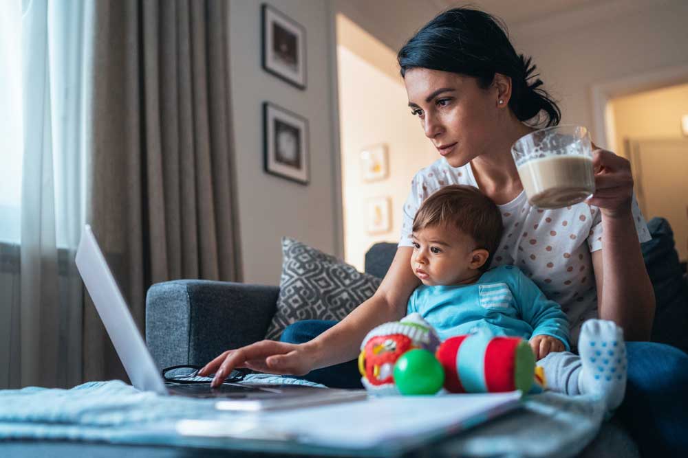mom with baby looking at laptop