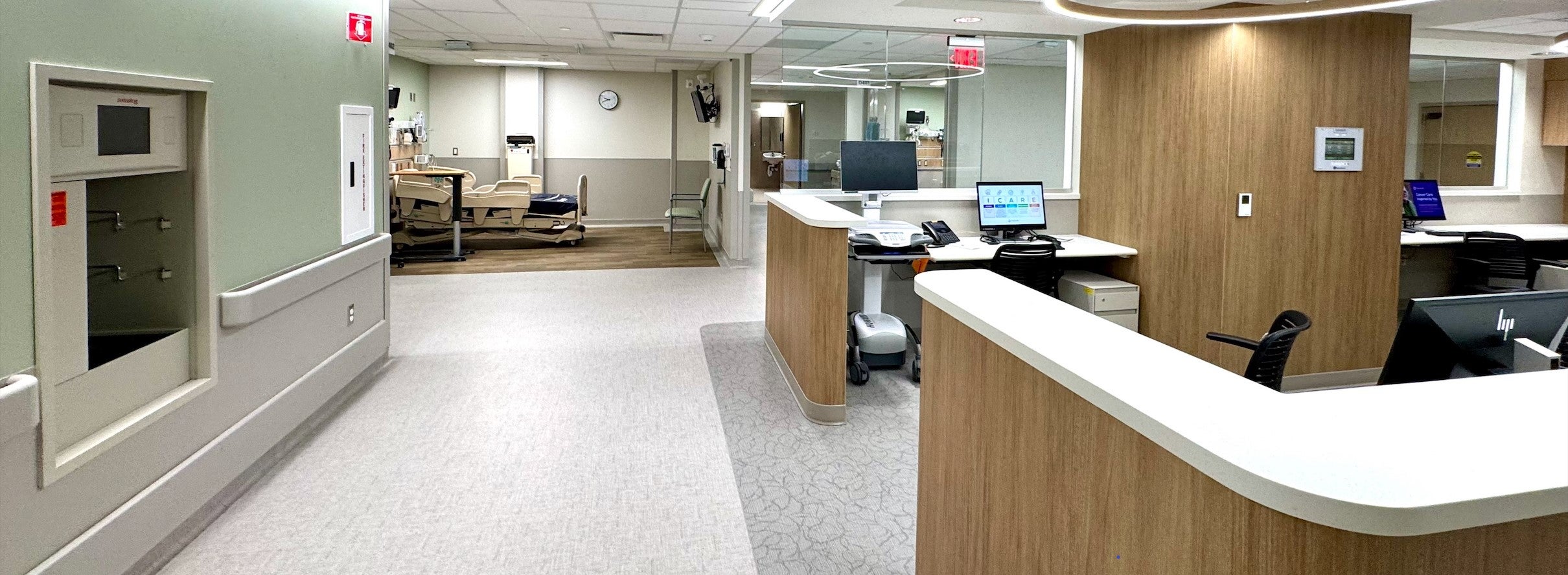 new nurses' station with patient room visible at end of hall