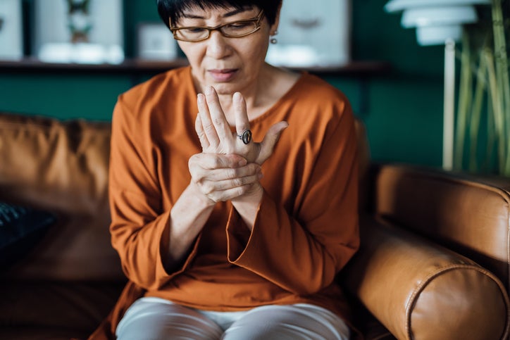 woman in pain rubbing her hand