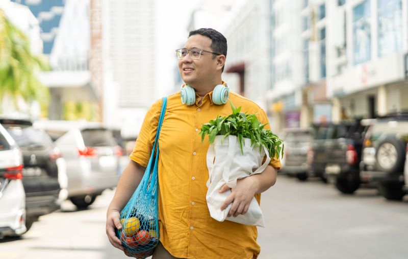 man walking with groceries