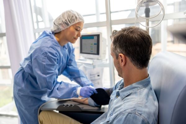 Doctor treating patient in chair
