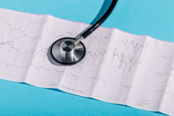 A stethoscope sits over a reading of vitals