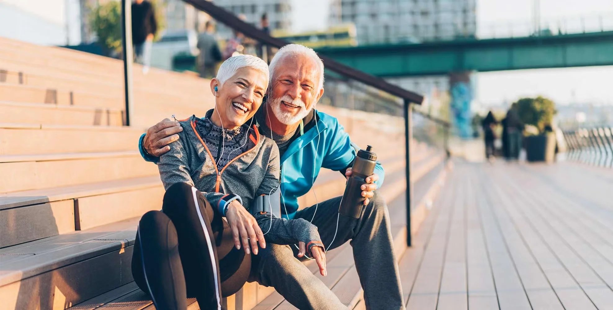 A couple take a rest during an outdoor workout