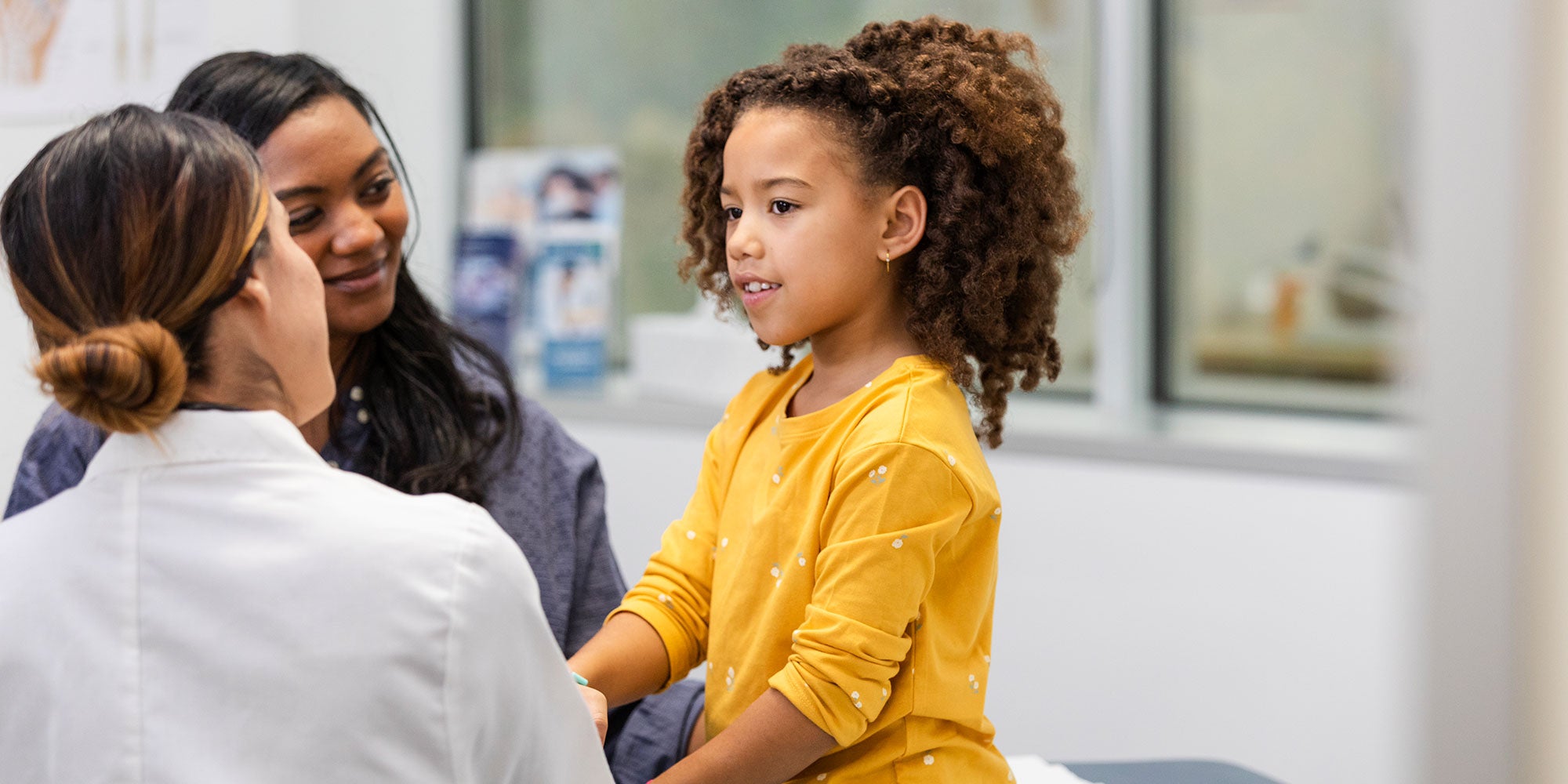 mother and daughter talking with provider