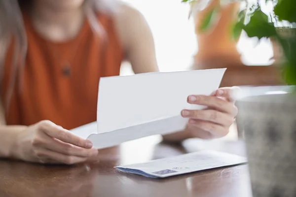 A woman looks at a letter