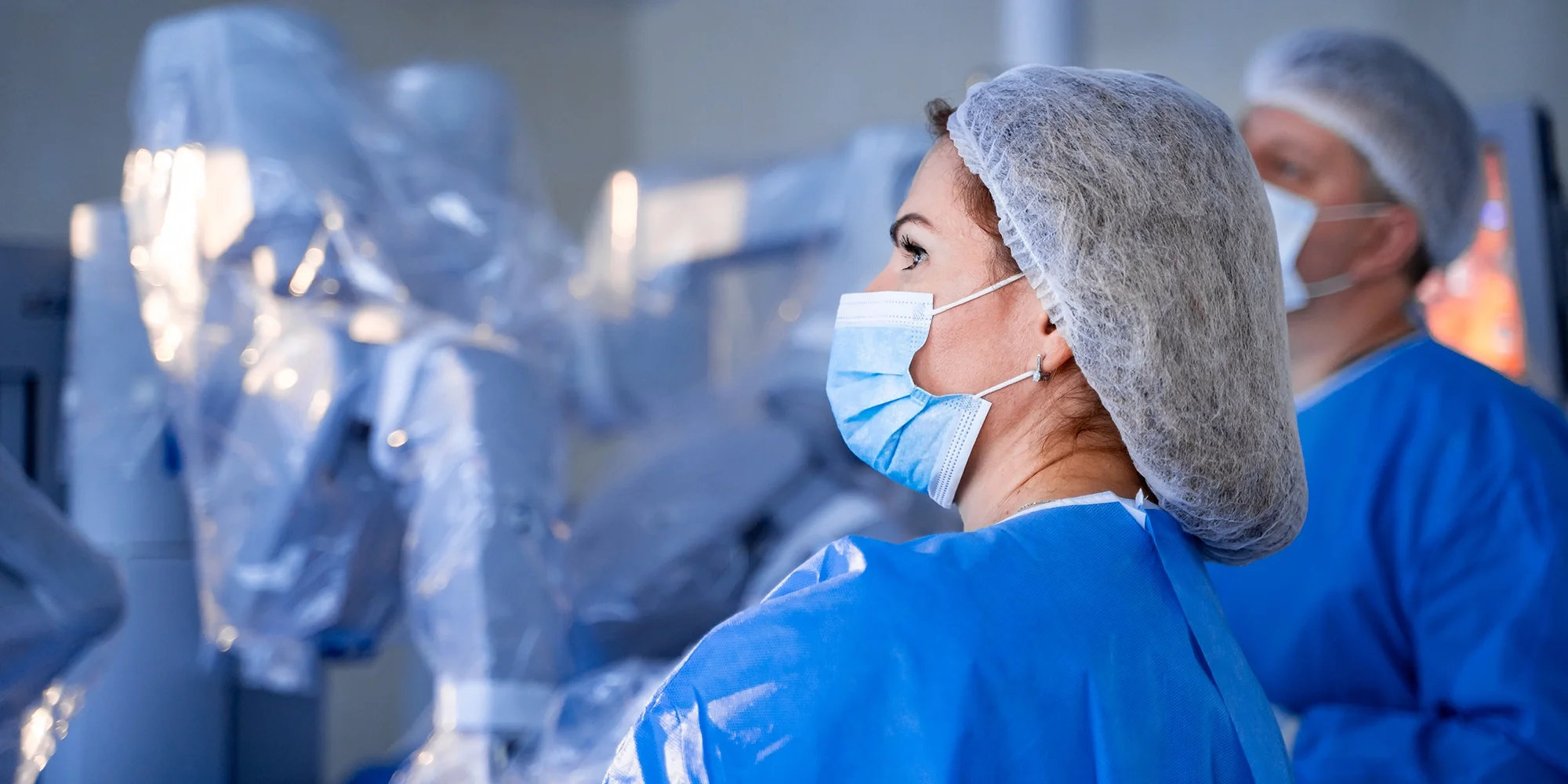 A group of robotic surgeons prepare to perform surgery