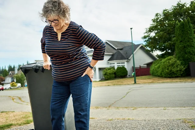 An elderly woman brings in the trash and has sudden pain in her hips.