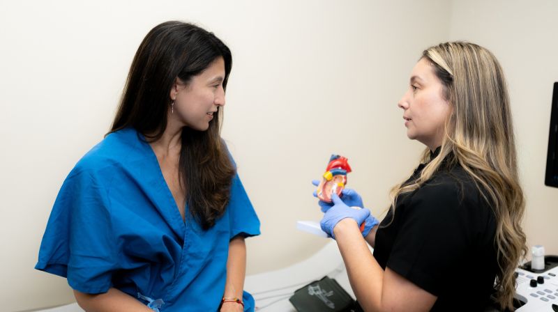 Provider with patient holding heart model