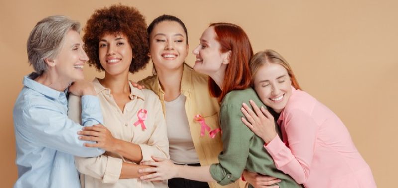 group of women wearing pink ribbons for breast cancer awareness