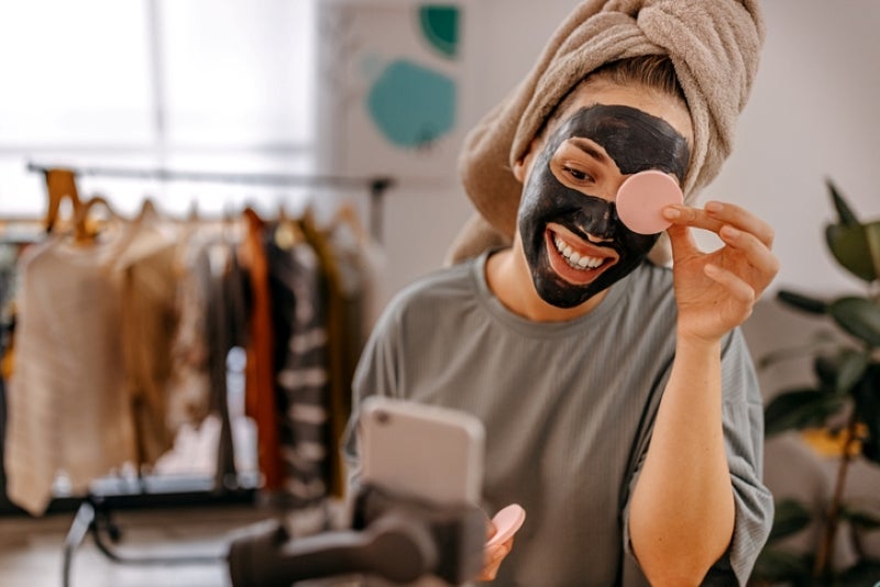 millennial applying a skincare mask