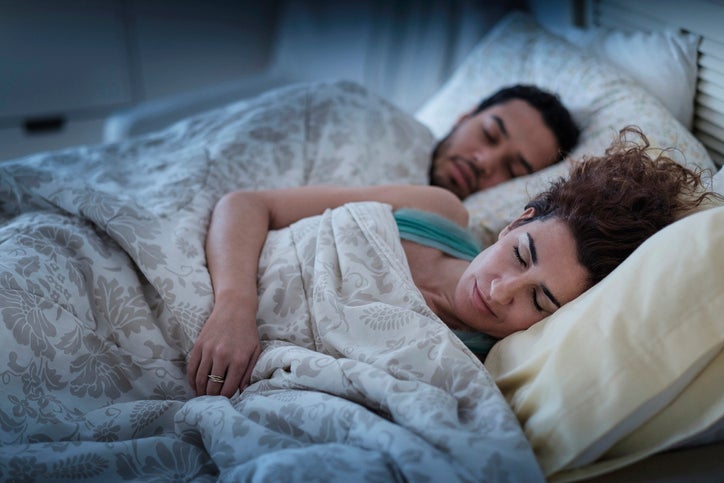 Couple Sleeping In Bed