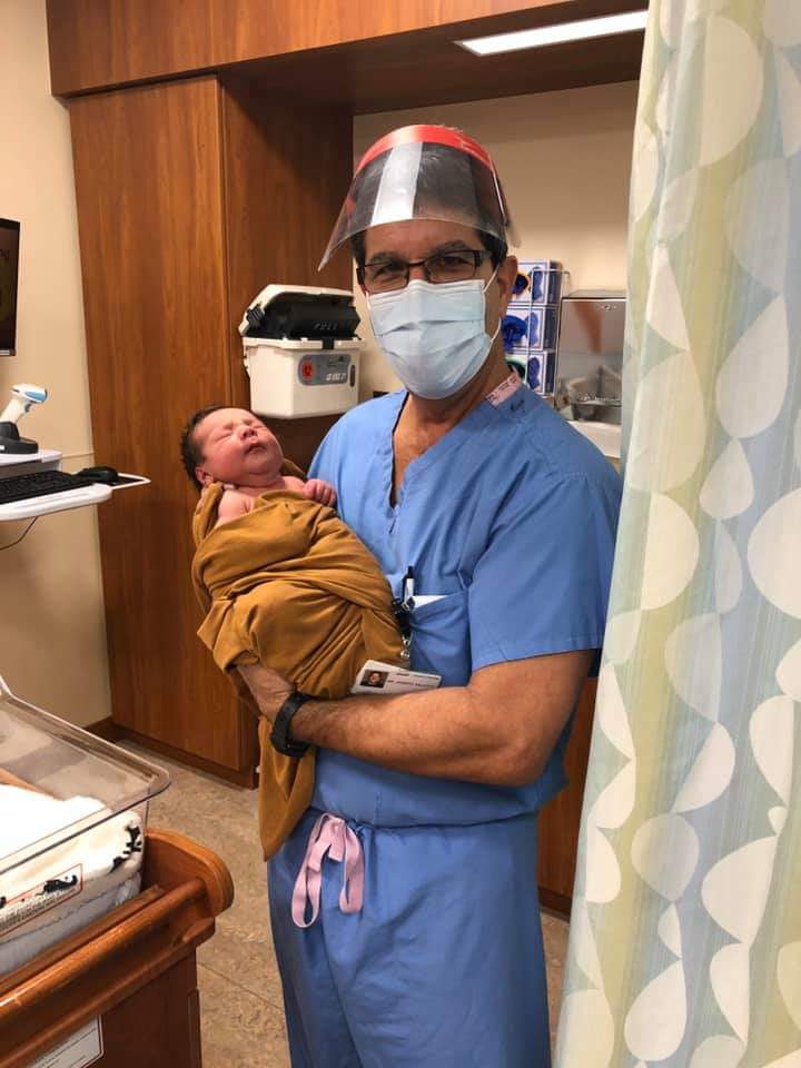 A nurse holding a newborn baby