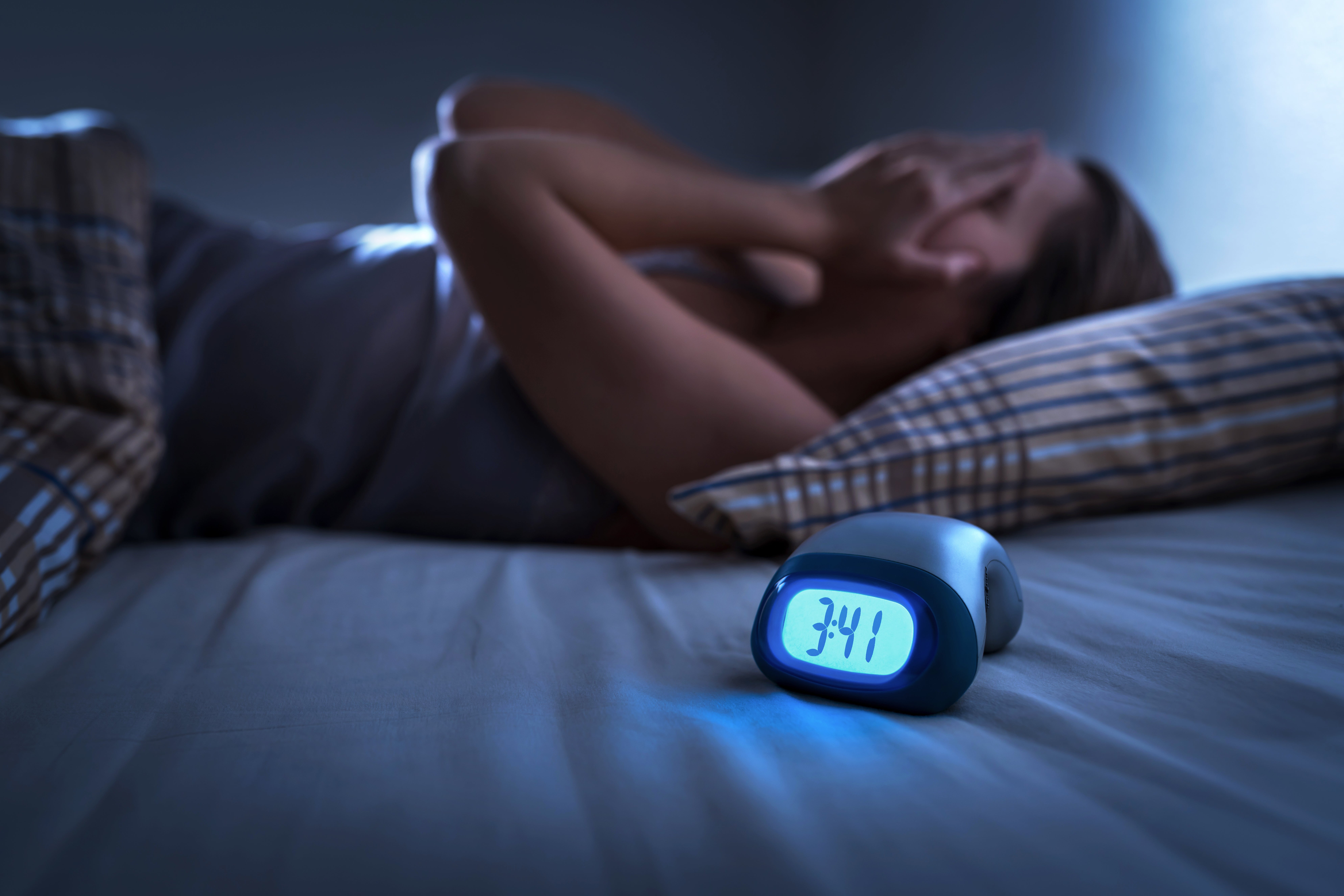 adult in bed not sleeping