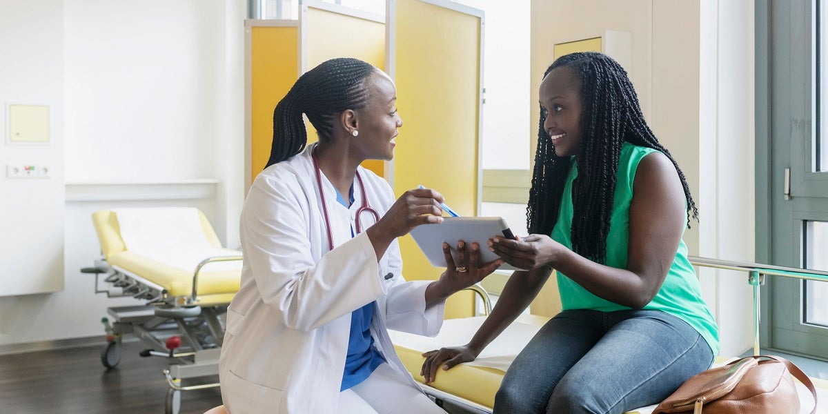 Female doctor speaking with female patient about her care plan.