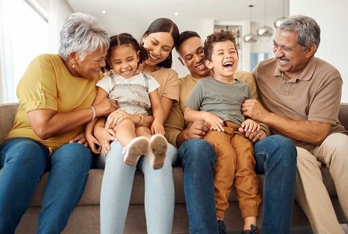 Family smiling on couch