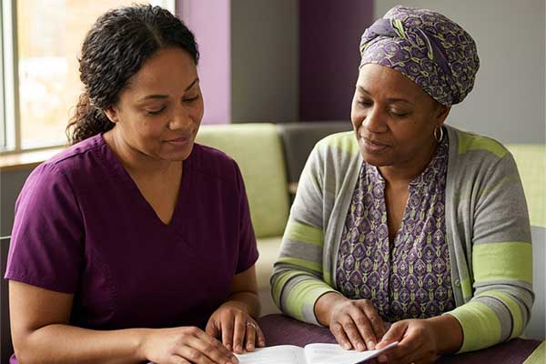 Two women go over community health resources