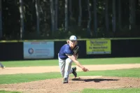 A young man named Paxton pitches a baseball from the mound